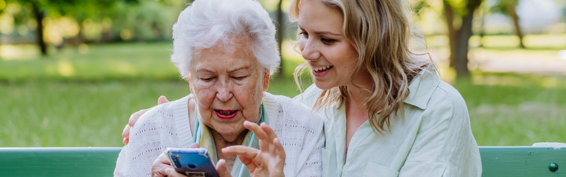 caregiver assist her patient in using phone